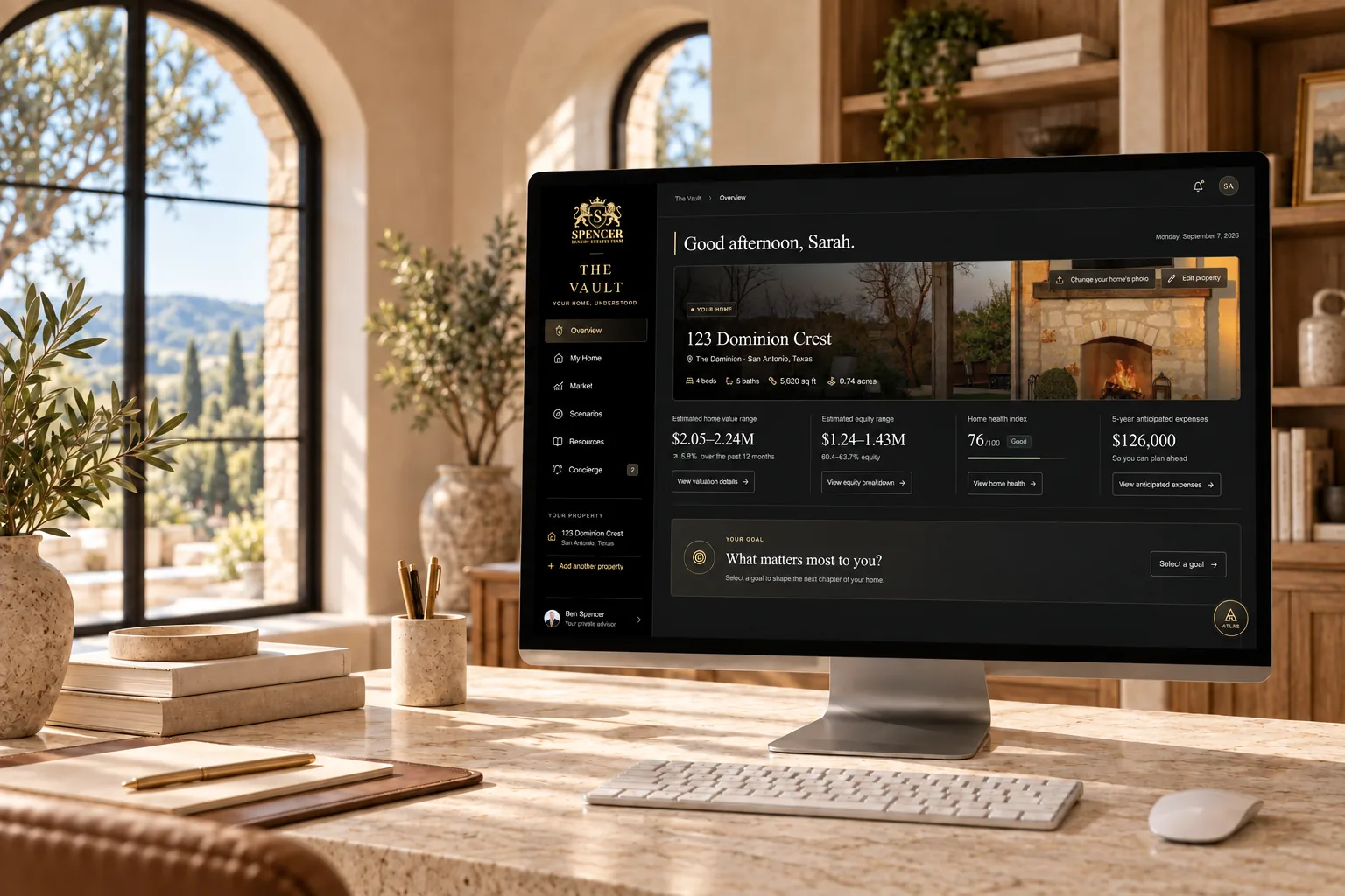 The Vault dashboard displayed on a desktop computer on a pale stone desk in a Mediterranean home office.